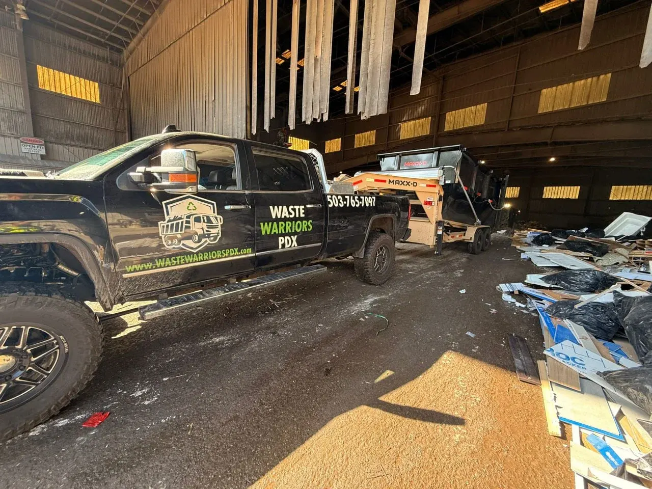Waste Warriors PDX truck unloading at a transfer station